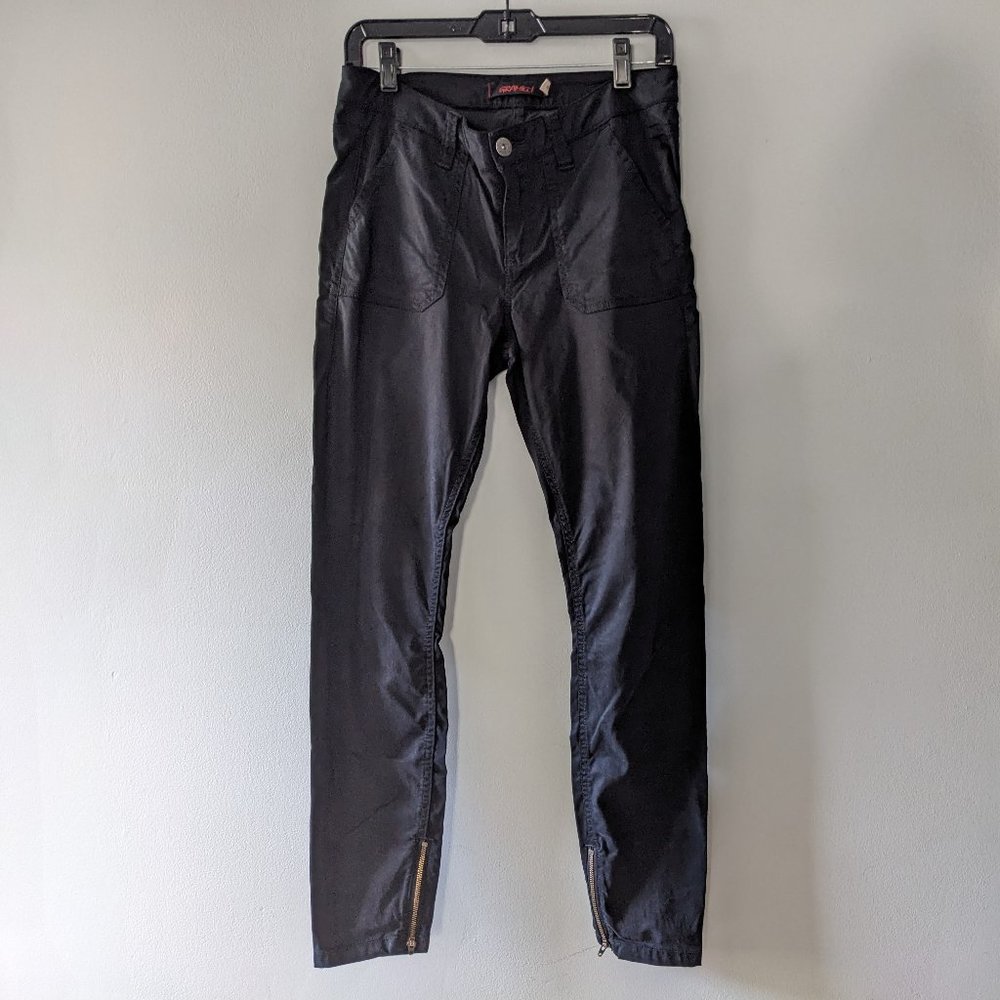 Gramicci women's black pants with flap back pockets and zippers on the bottom.